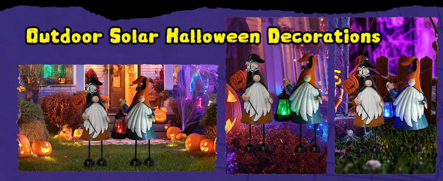 pair of hallowen themed gnome garden stakes in the garden