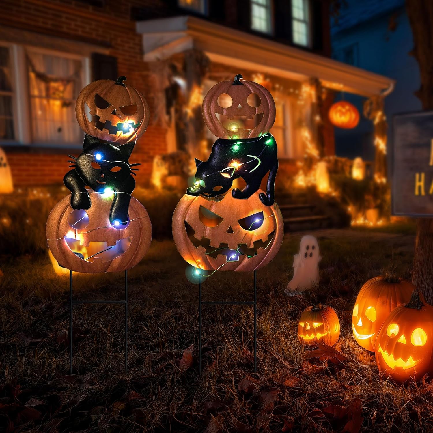 a halloween garden stakes in the frontyard at night