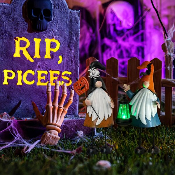 halloween gnome garden stakes in a garden